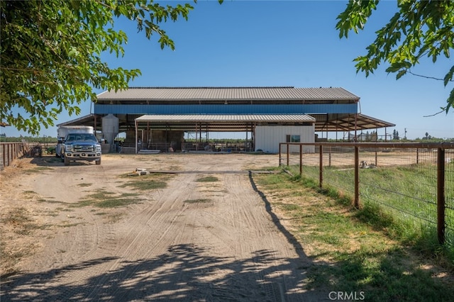 view of front of house with an outbuilding and a rural view