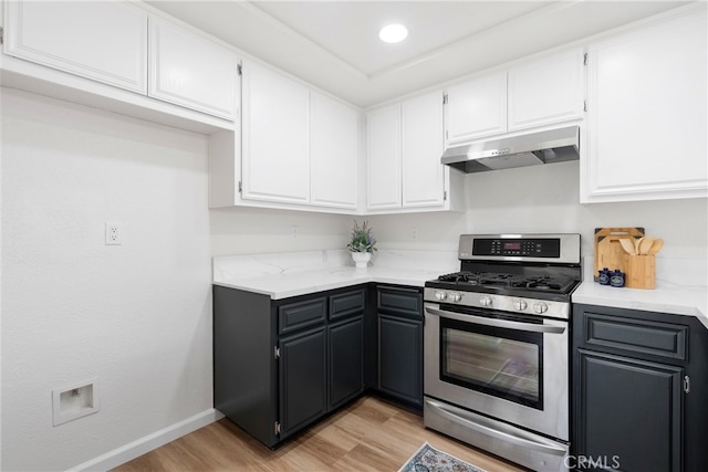 kitchen featuring gas range, white cabinets, ventilation hood, and light hardwood / wood-style floors