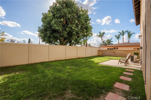 view of yard featuring a patio and central AC