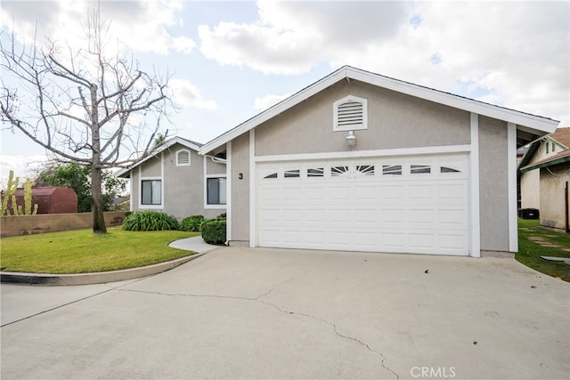 ranch-style house featuring a front yard and a garage