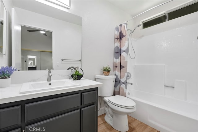 full bathroom featuring toilet, hardwood / wood-style floors, shower / tub combo with curtain, and vanity