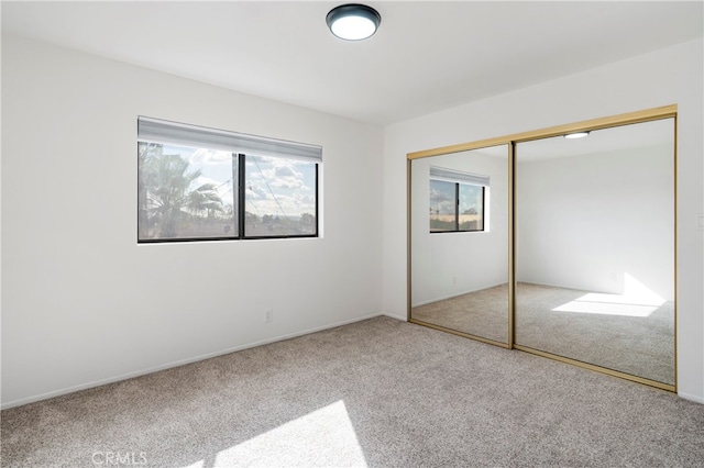 unfurnished bedroom featuring a closet and carpet flooring