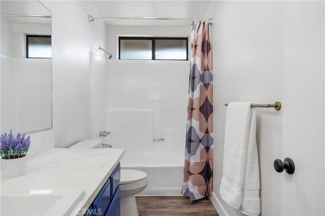 full bathroom featuring vanity, toilet, wood-type flooring, and shower / bath combination with curtain