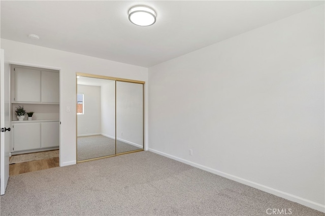 unfurnished bedroom featuring a closet and carpet