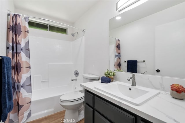 full bathroom with vanity, hardwood / wood-style floors, shower / bath combo with shower curtain, and toilet