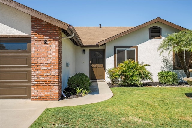 doorway to property featuring a lawn