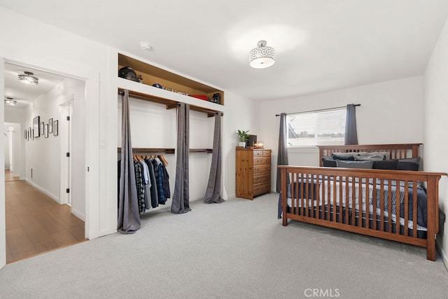 bedroom with light wood-type flooring and a closet