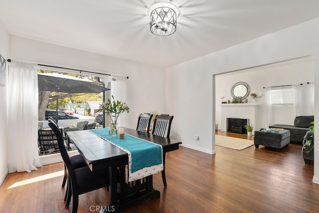 dining space featuring a fireplace and hardwood / wood-style floors