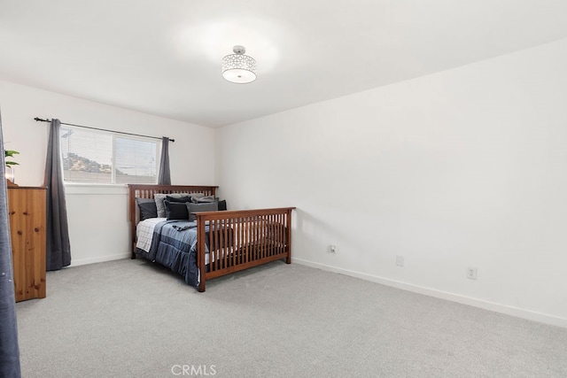 bedroom featuring light carpet