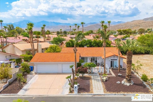 view of front of home featuring a mountain view and a garage