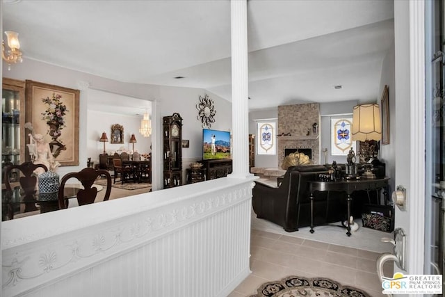 interior space featuring a fireplace and decorative columns