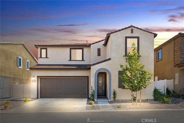 mediterranean / spanish-style house with a garage