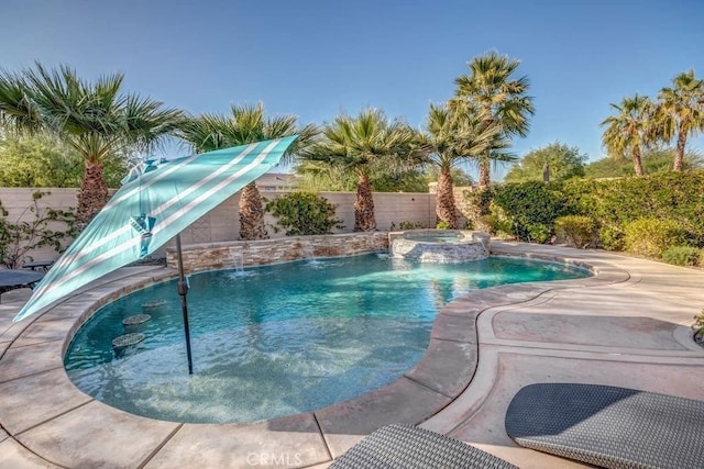 view of pool with pool water feature and an in ground hot tub