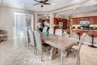 dining space with ceiling fan and light tile patterned floors