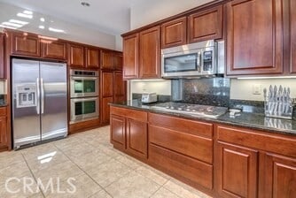 kitchen featuring appliances with stainless steel finishes and light tile patterned floors