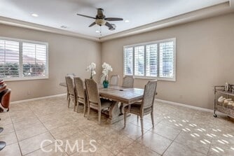 dining space featuring a wealth of natural light, ceiling fan, and light tile patterned flooring