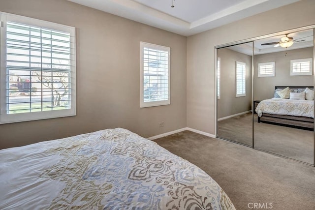 bedroom with multiple windows, carpet flooring, and ceiling fan