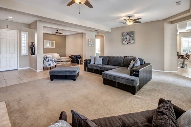 living room with ceiling fan and light colored carpet