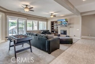 tiled living room with ceiling fan