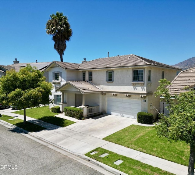 view of front facade with a front yard and a garage