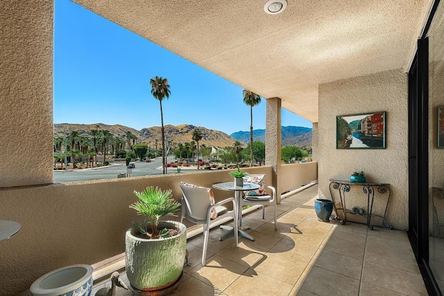 view of patio / terrace featuring a mountain view and a balcony