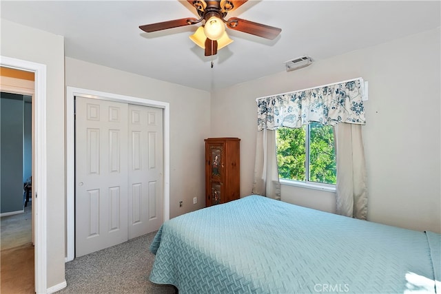 carpeted bedroom with a closet and ceiling fan