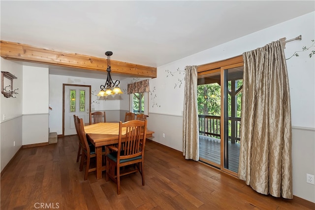 dining space featuring an inviting chandelier, beamed ceiling, and dark wood-type flooring