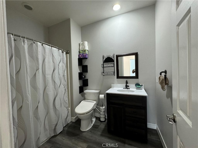 bathroom featuring vanity, hardwood / wood-style flooring, and toilet