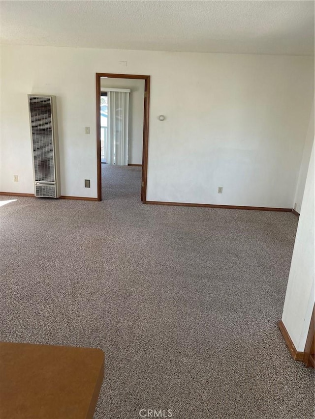 carpeted empty room featuring a textured ceiling