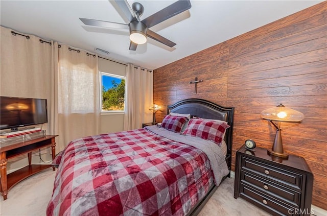 46469 Wallu Ln, Ahwahnee, CA 93601 - bedroom featuring a ceiling fan, visible vents, wooden walls, and light carpet