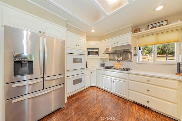 46469 Wallu Ln, Ahwahnee, CA 93601 - kitchen with light countertops, white cabinets, stainless steel appliances, under cabinet range hood, and dark wood-style floors