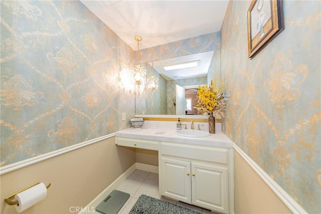 46469 Wallu Ln, Ahwahnee, CA 93601 - bathroom featuring a skylight, baseboards, wallpapered walls, vanity, and tile patterned flooring