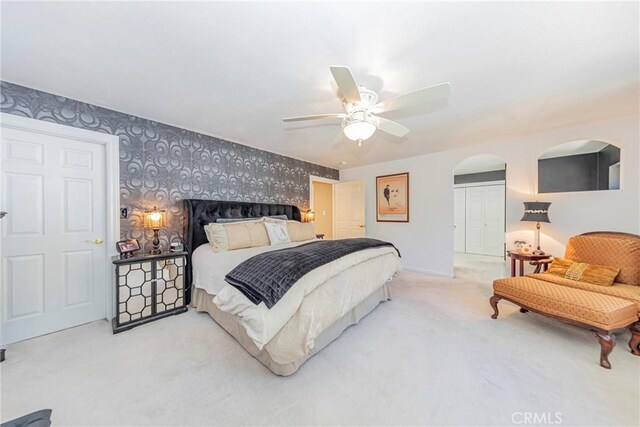 46469 Wallu Ln, Ahwahnee, CA 93601 - carpeted bedroom with a ceiling fan, wallpapered walls, baseboards, and an accent wall