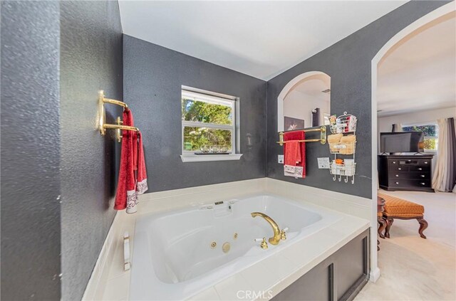 46469 Wallu Ln, Ahwahnee, CA 93601 - bathroom featuring a wealth of natural light, a whirlpool tub, and a textured wall