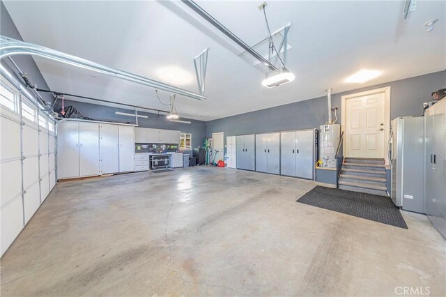 46469 Wallu Ln, Ahwahnee, CA 93601 - garage featuring gas water heater, a garage door opener, and freestanding refrigerator
