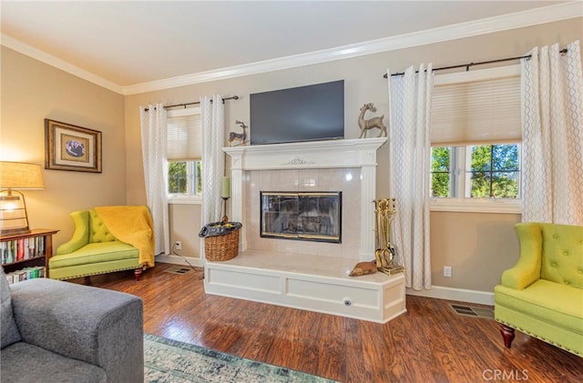 46469 Wallu Ln, Ahwahnee, CA 93601 - living room with a tiled fireplace, visible vents, crown molding, and wood finished floors