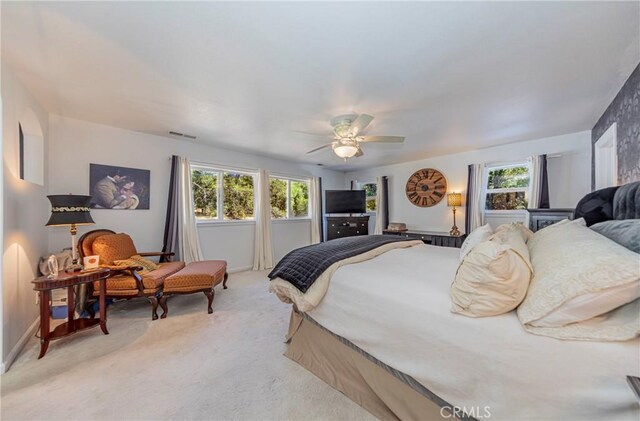 46469 Wallu Ln, Ahwahnee, CA 93601 - bedroom with a ceiling fan, light carpet, multiple windows, and visible vents