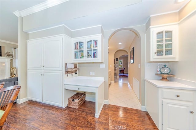 46469 Wallu Ln, Ahwahnee, CA 93601 - interior space with white cabinets, arched walkways, crown molding, and glass insert cabinets