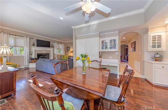 46469 Wallu Ln, Ahwahnee, CA 93601 - dining space featuring arched walkways, dark wood-type flooring, crown molding, and ceiling fan