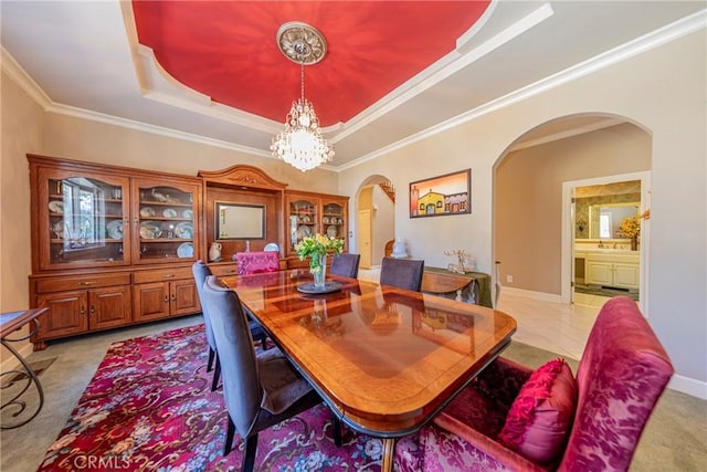 46469 Wallu Ln, Ahwahnee, CA 93601 - dining room with a tray ceiling, baseboards, arched walkways, and an inviting chandelier