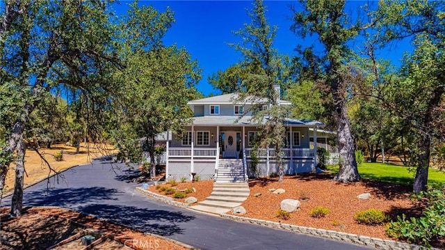 46469 Wallu Ln, Ahwahnee, CA 93601 - view of front facade with covered porch, aphalt driveway, and stairs