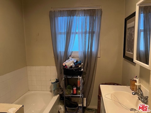 bathroom with vanity and a bathing tub