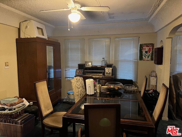 dining space with ceiling fan and a textured ceiling