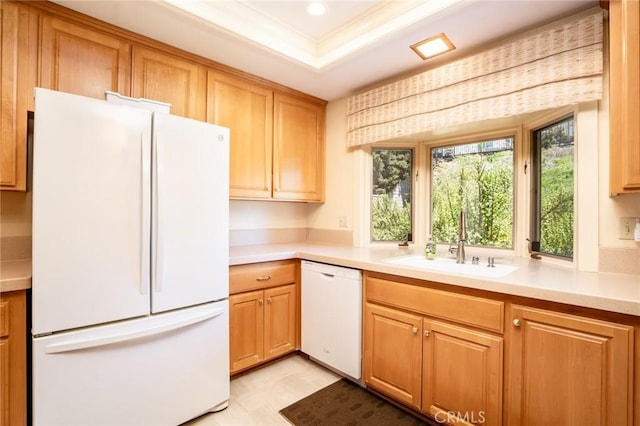 kitchen with a tray ceiling, sink, white appliances, and ornamental molding