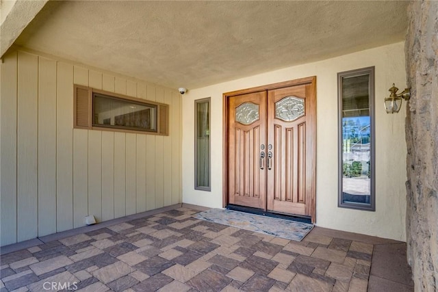 view of exterior entry with covered porch