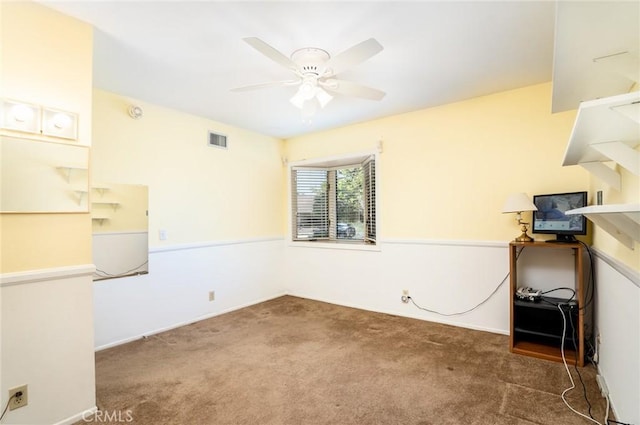 carpeted spare room featuring ceiling fan