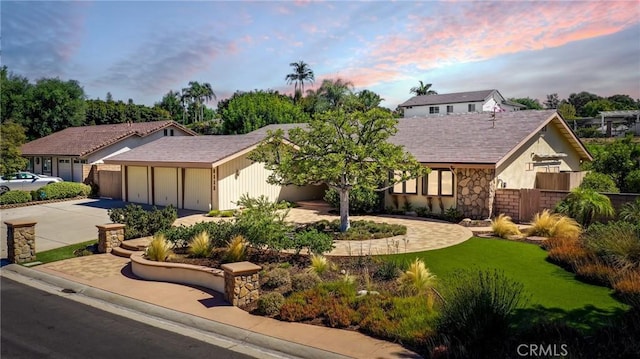 view of front of property with a garage and a yard