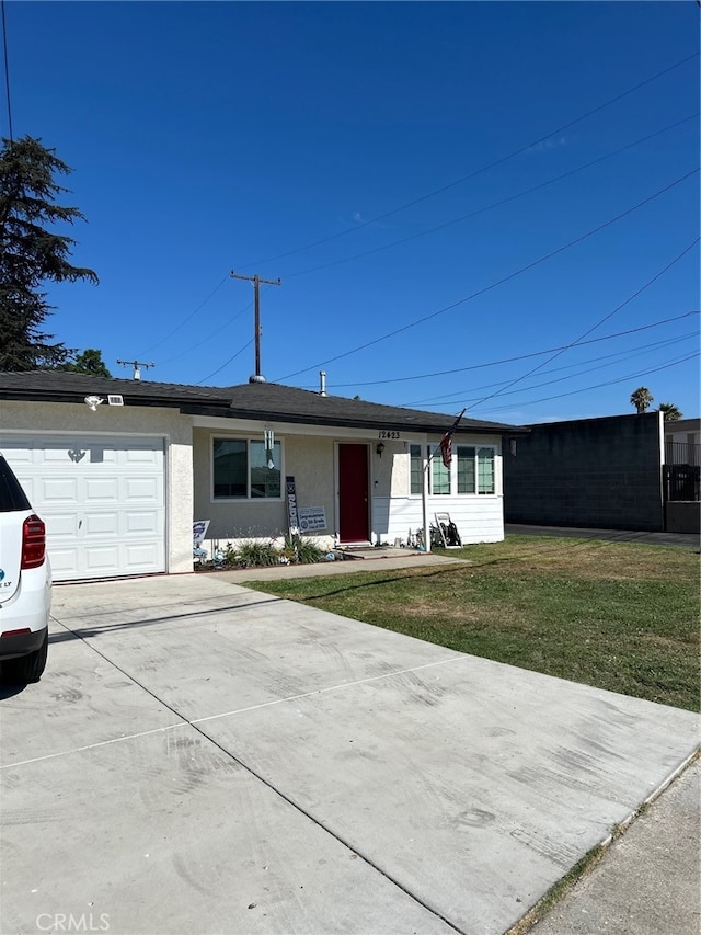 single story home with a front yard and a garage