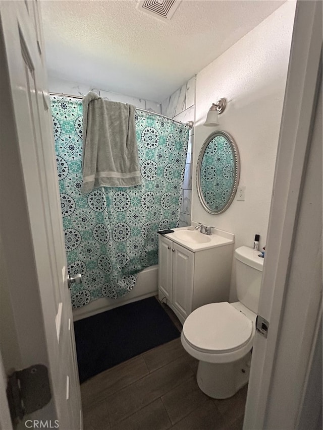 full bathroom with vanity, wood-type flooring, a textured ceiling, toilet, and shower / tub combo with curtain