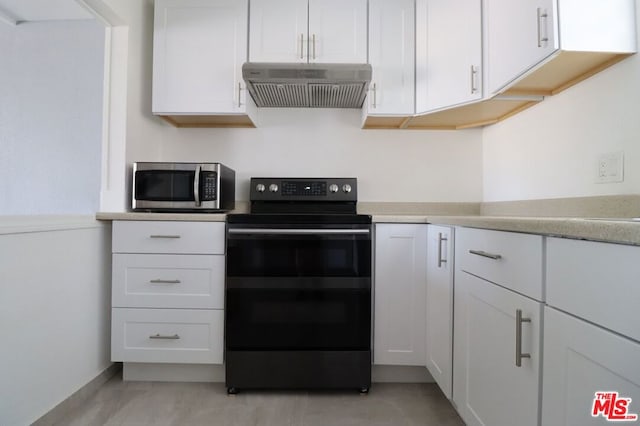 kitchen with black electric range, white cabinetry, and range hood